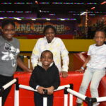 Four children in a roller skating rink