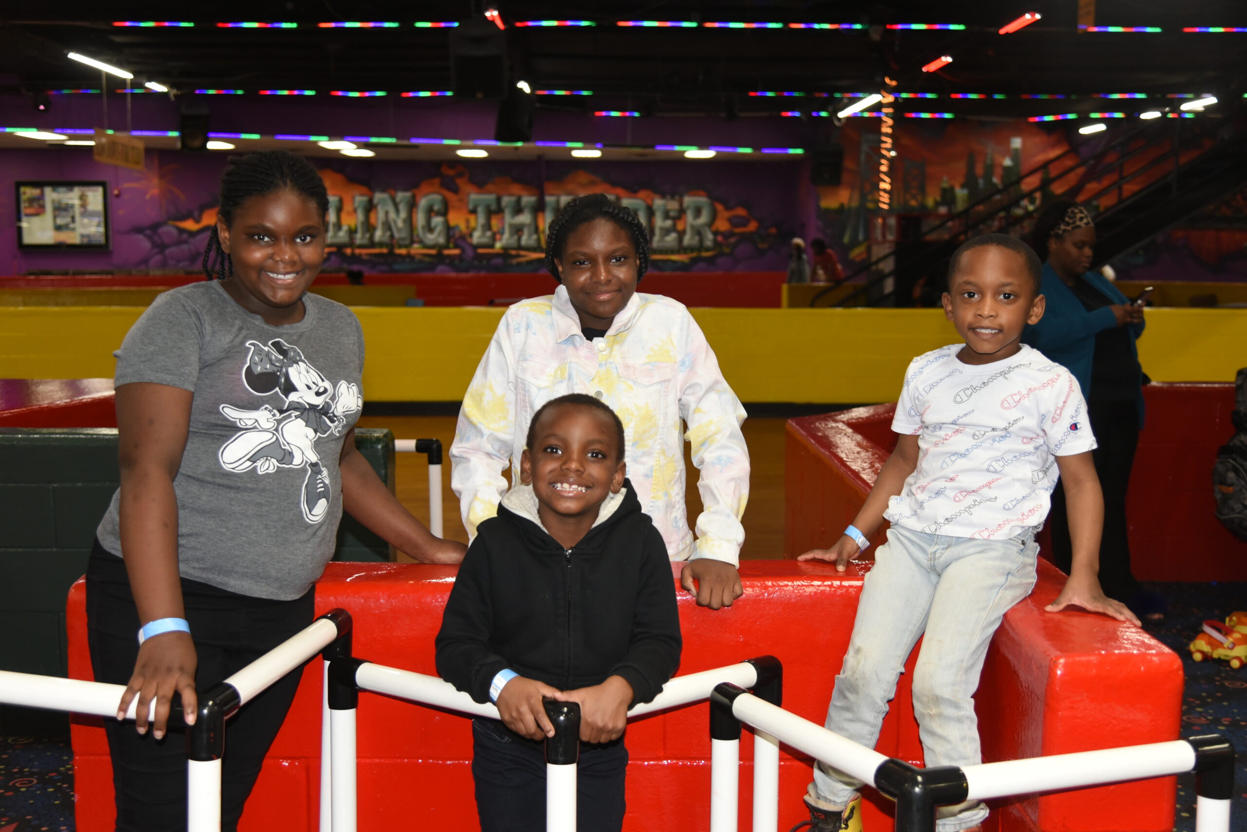 Four children in a roller skating rink