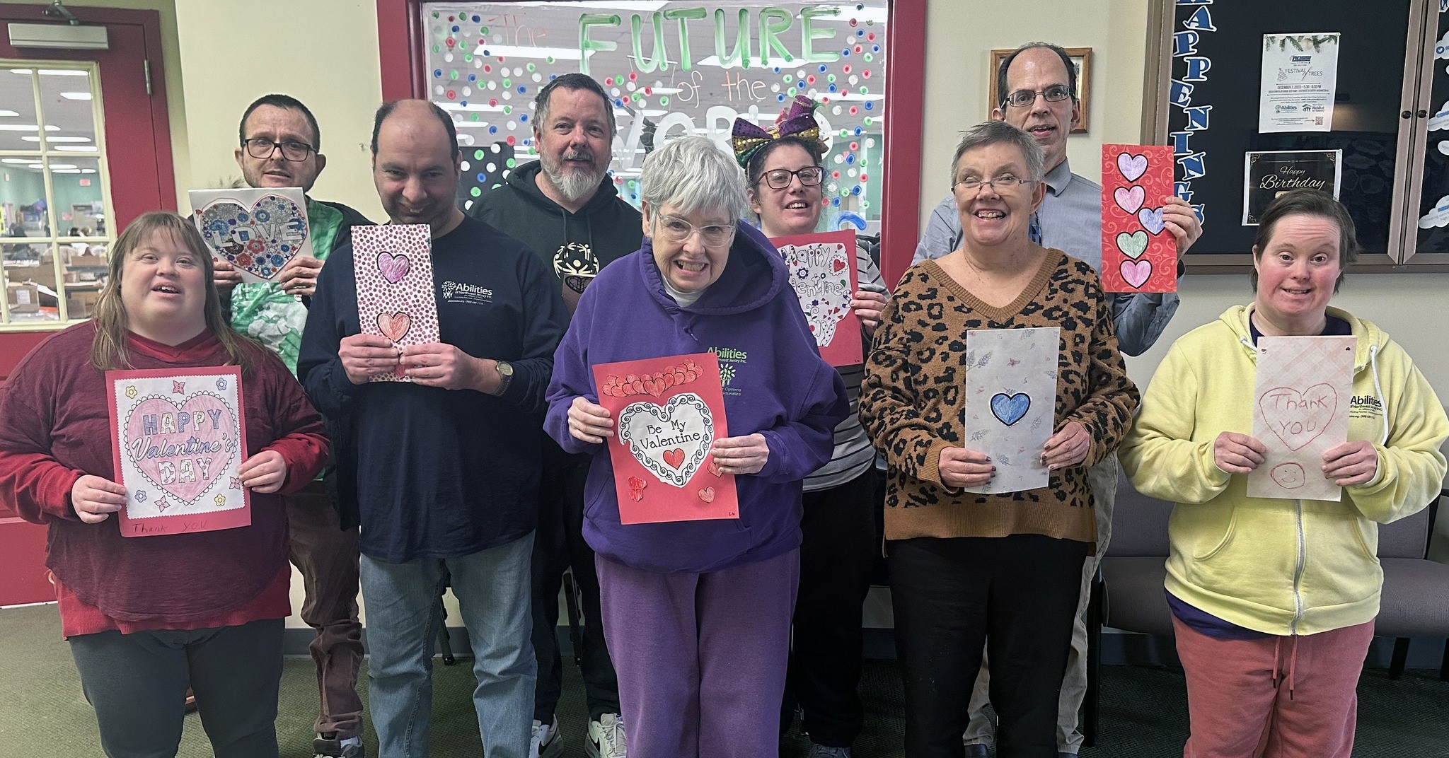 Group of people displaying Valentine's Day cards they created