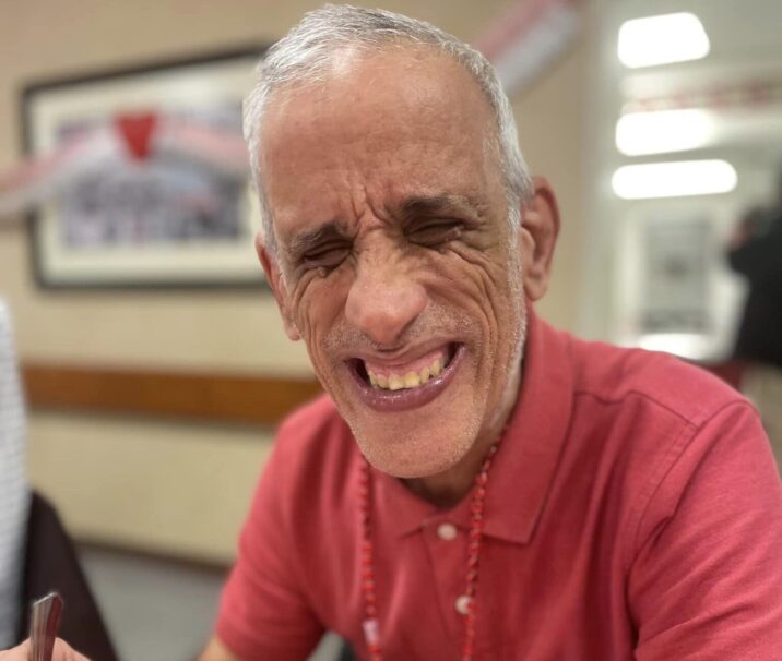 Man smiling and eating a meal