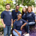 Five people from Archway Programs sitting and standing near a bench