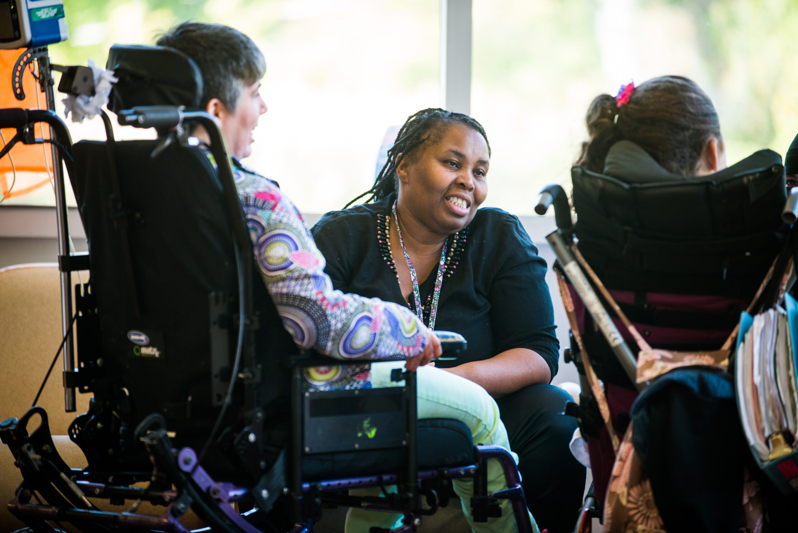 woman in a wheelchair with a smiling woman