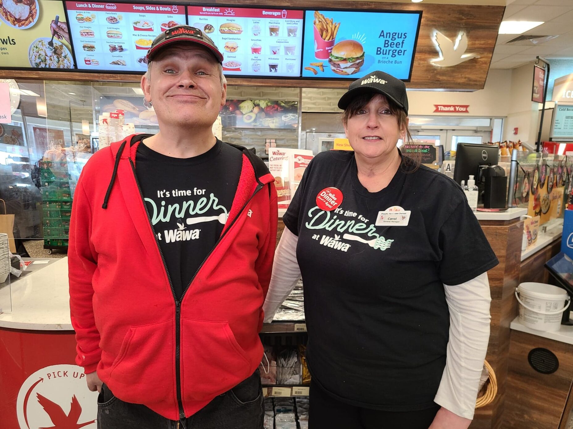 Two employees at a deli counter