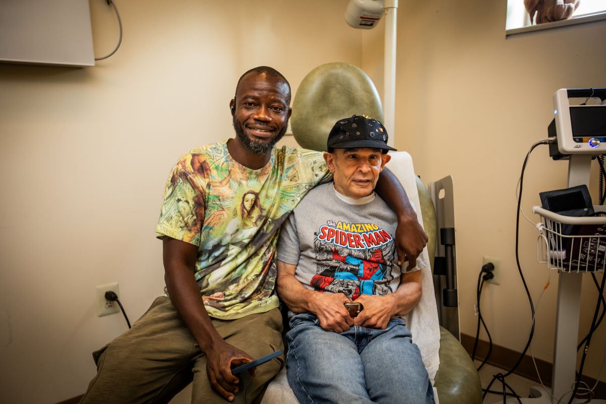 man with his arm around the shoulder of a man with intellectual disability