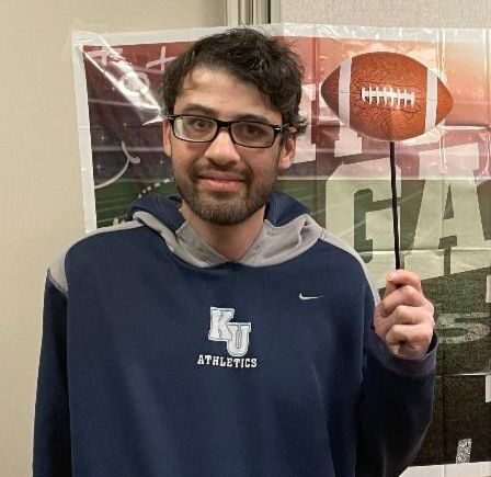 Man holding a football cutout