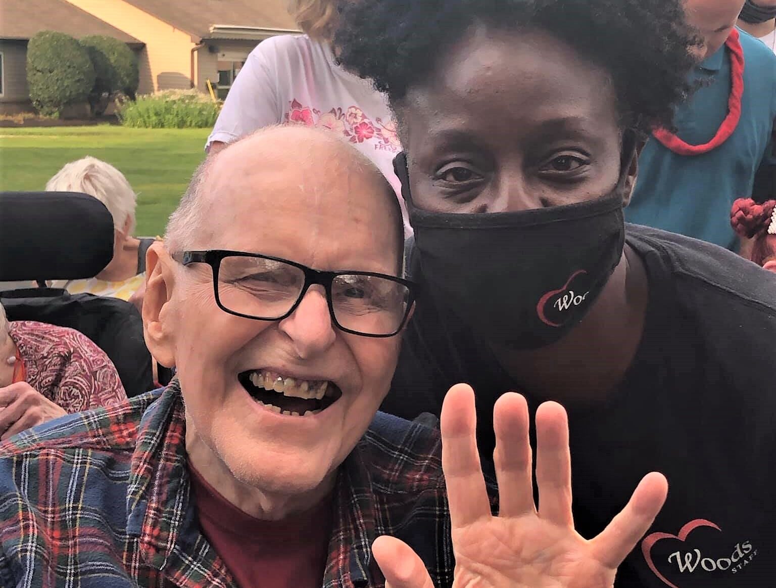 older man with a young woman who is wearing a Covid mask