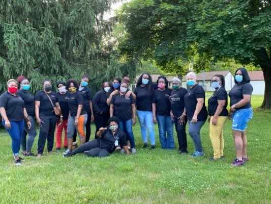 large group of women wearing black shirts