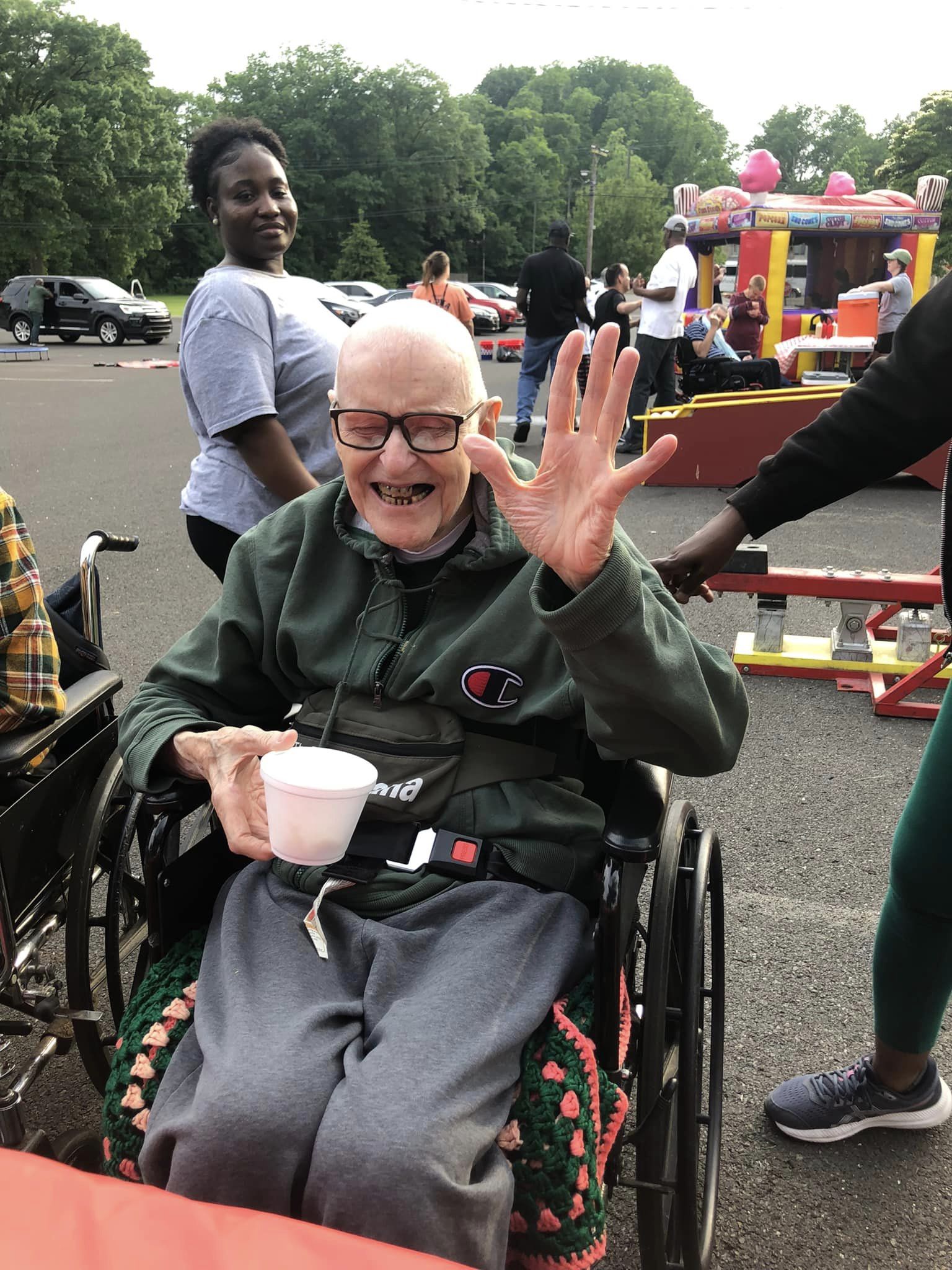 older gentleman in a wheelchair smiling