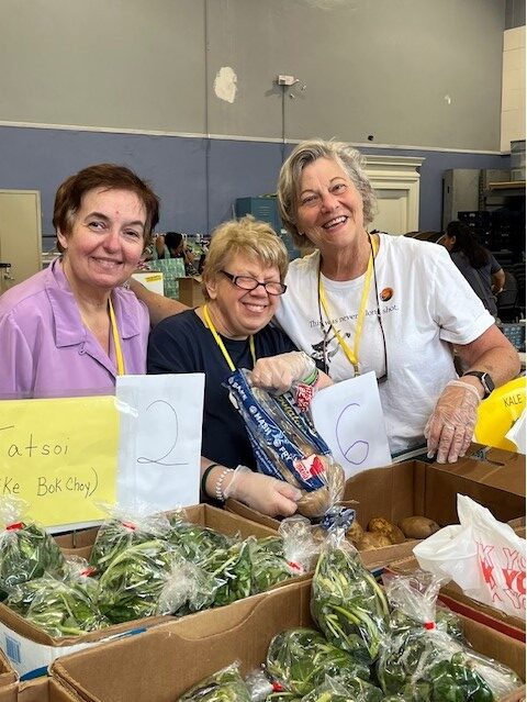 Three women volunteering at the food bank