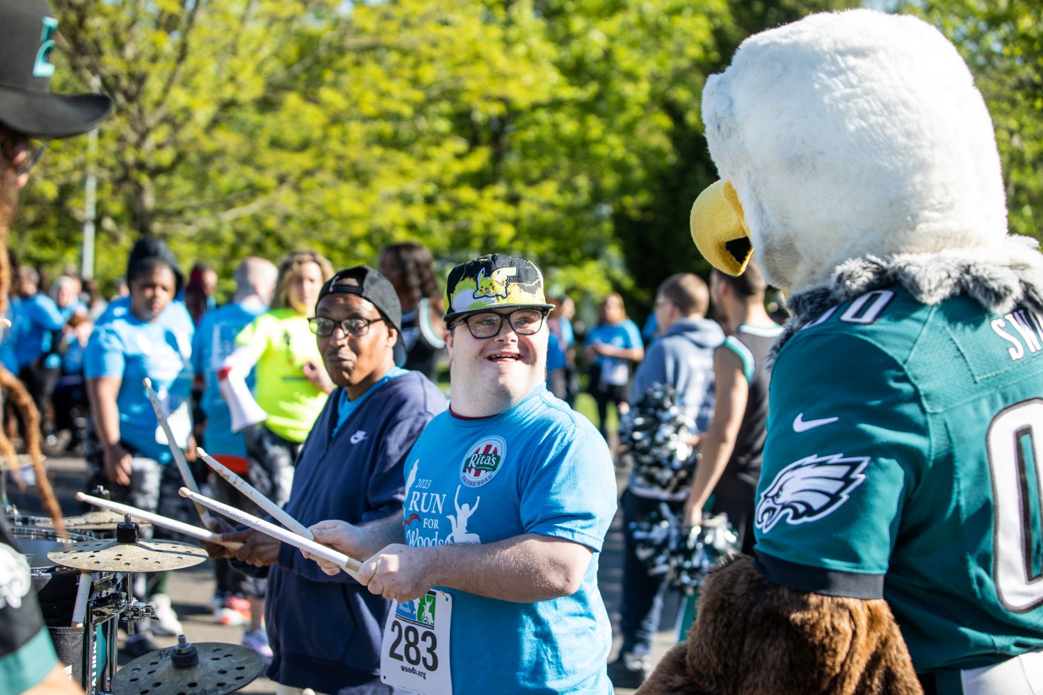 Eagles' mascot Swoop watches two men playing the drums