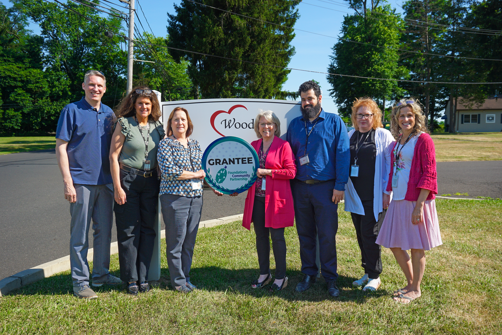 Group of people at Woods Services accepting a grant from FCP